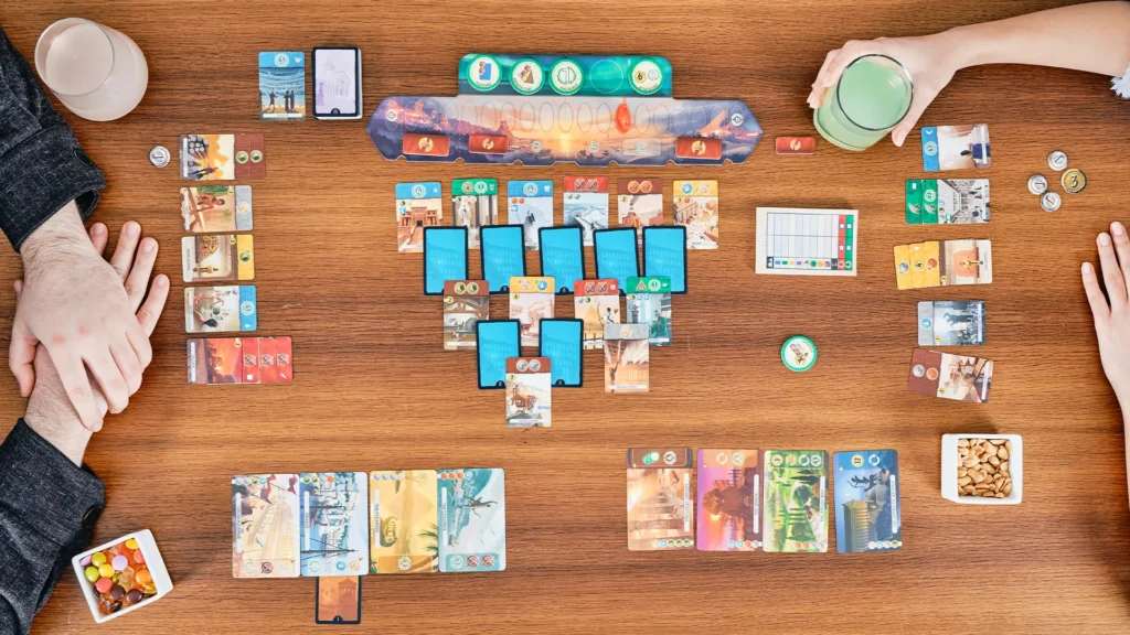 Players at a table during a game of 7 Wonders Duel.